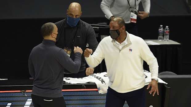 Philadelphia 76ers head coach Doc Rivers (right) meets with LA Clippers head coach Tyronn Lue